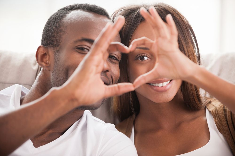 Couple making heart shape with hands